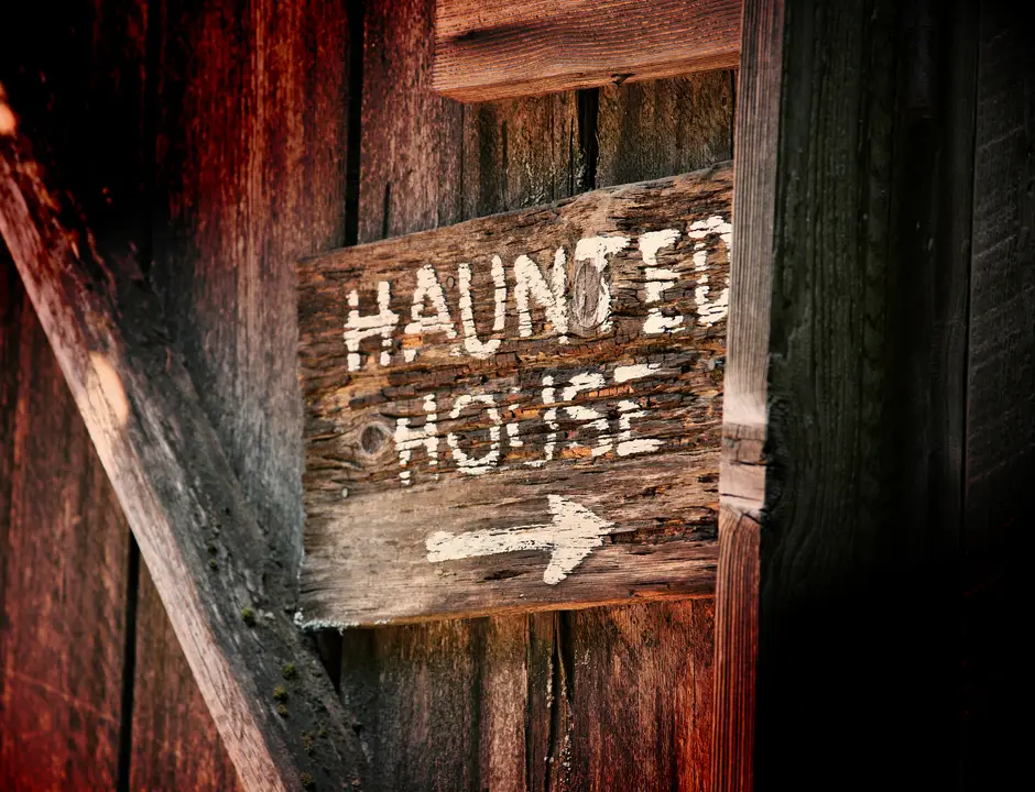 A "Haunted House" sign with an arrow pointing towards the entrance.